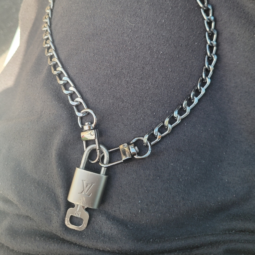 Rare Louis Vuitton Gunmetal padlock and unbranded chain.